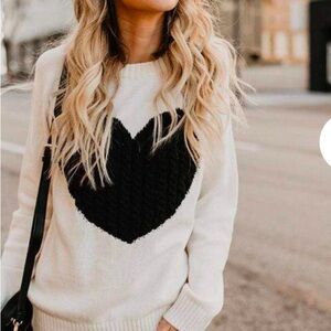 Cream sweater with black heart in large, gently used